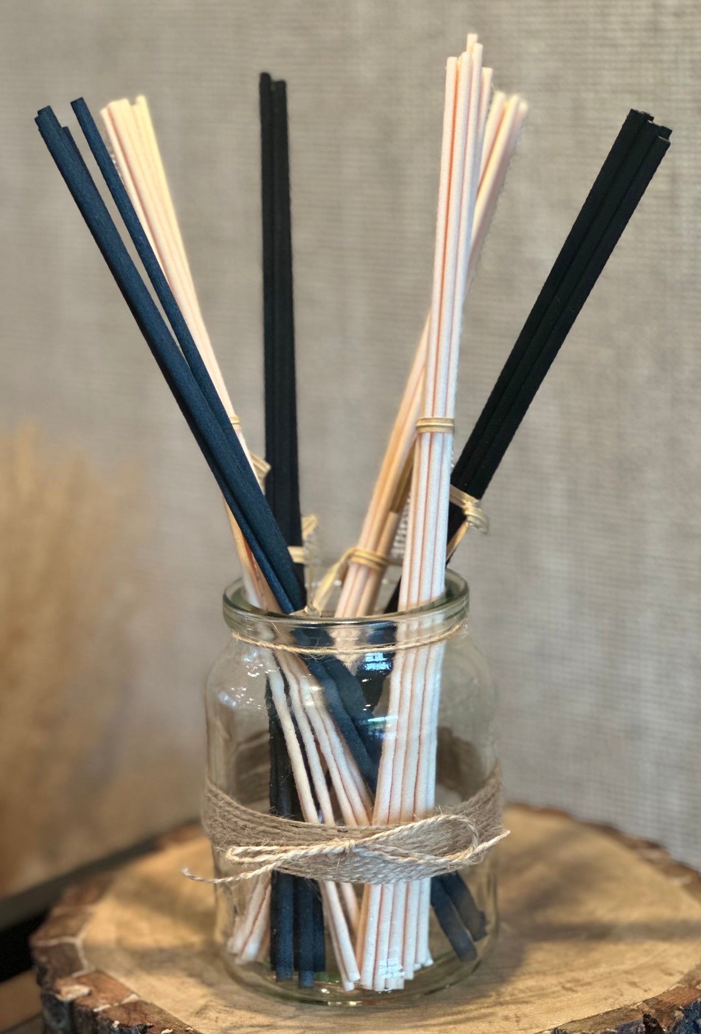 Rustic reed diffuser refills sticks, cream and black, in a jar.