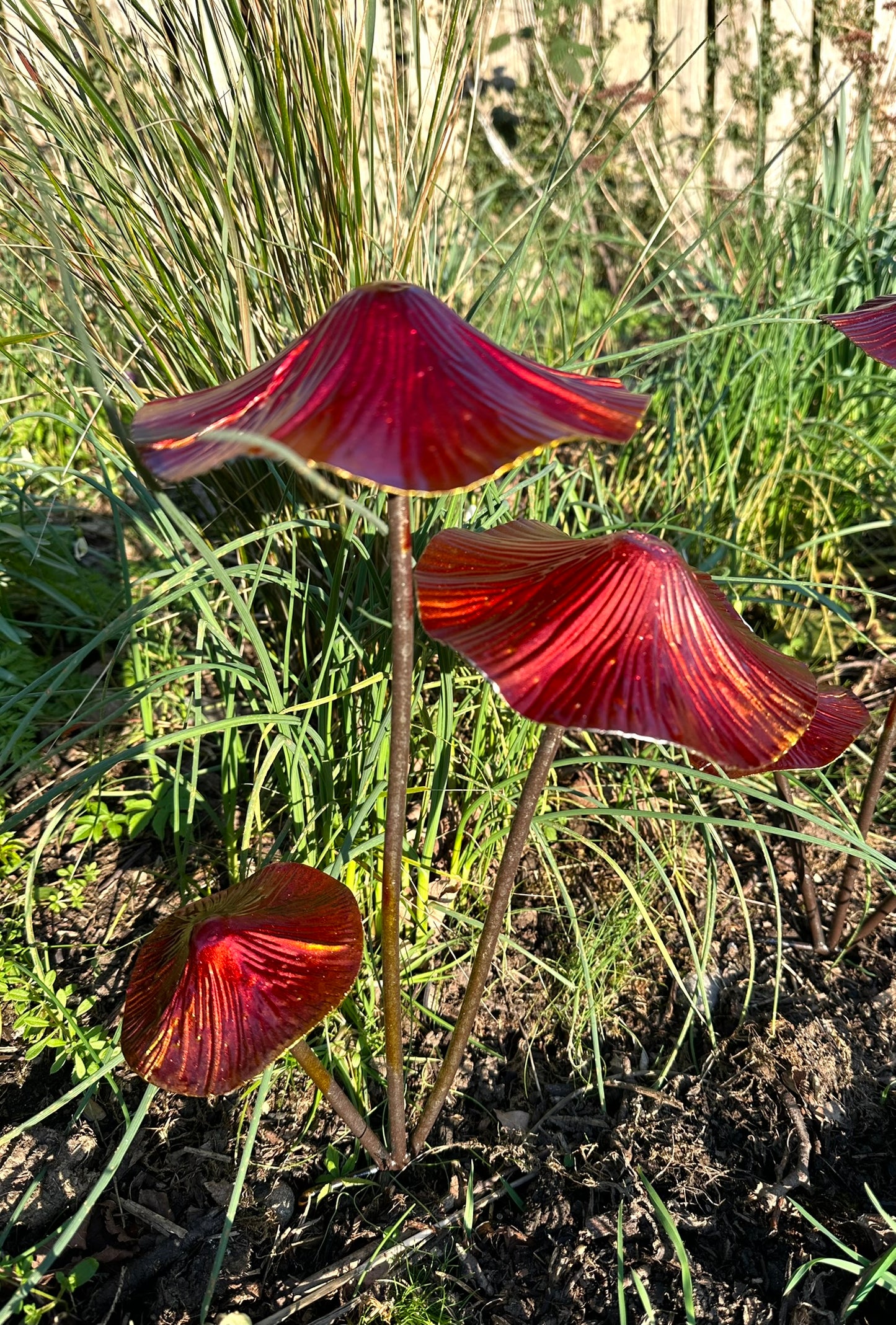 Whimsical outdoor mushroom ornaments in metallic finish for landscaped gardens, flower beds and nature inspired decor