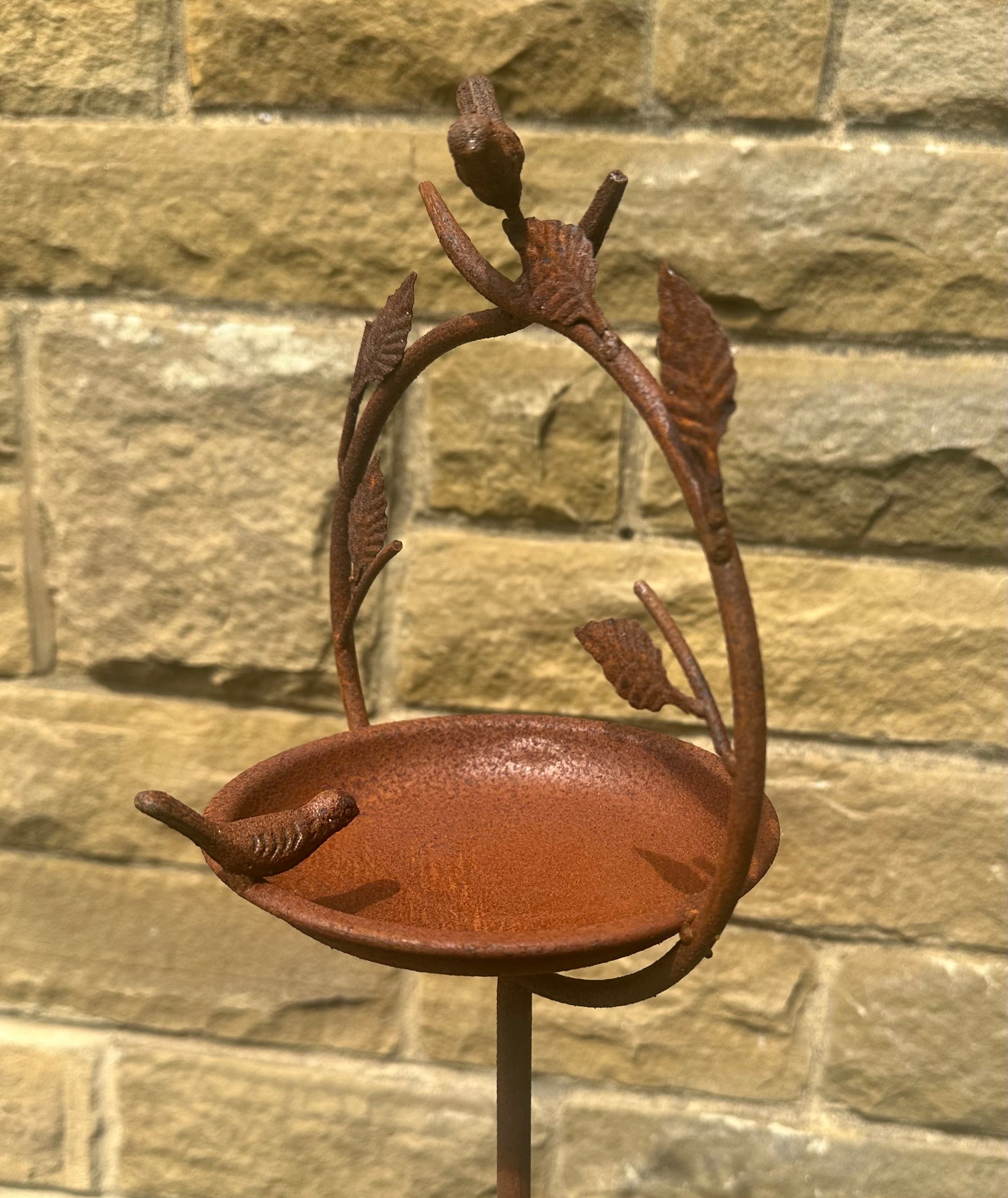 vintage-style metal birdbath on garden stake used as outdoor bird water dish