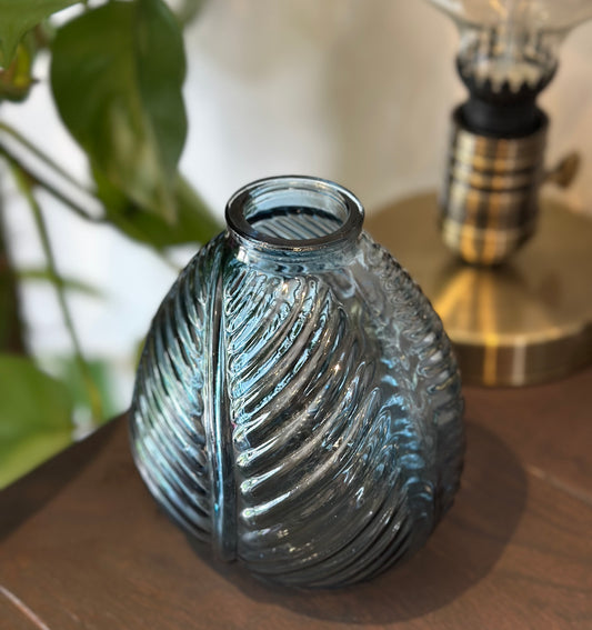 Blue glass vase with botanical leaf design for cool-toned decor or elegant flower display