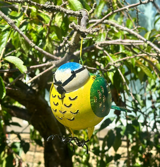 Decorative bird ornament hanging from a tree branch