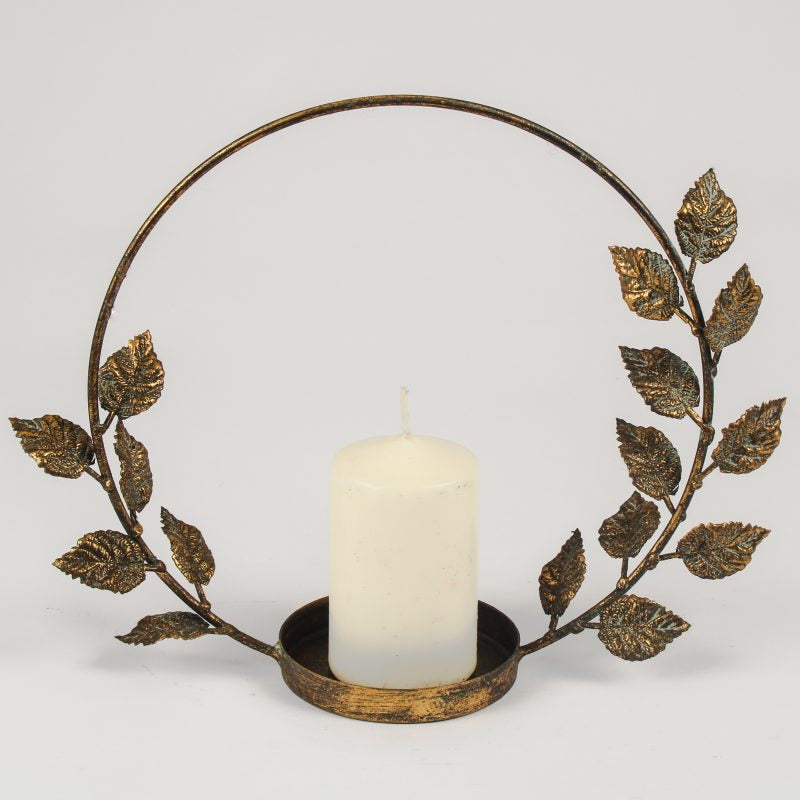 Brass leaf candle holder stand with elegant gold finish, decorative metal home accessory perfect for stylish dining tables and living room décor.