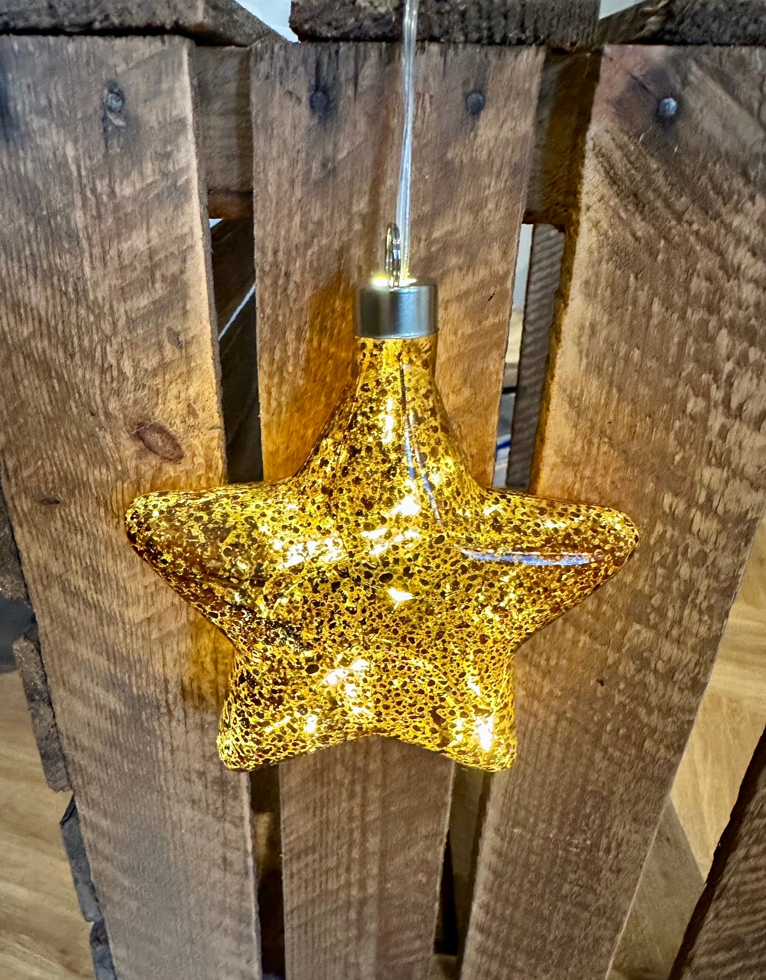 Bronze star-shaped glass hanging ornament with soft illumination, ideal for festive home styling or as a beautiful Christmas gift home lovers.