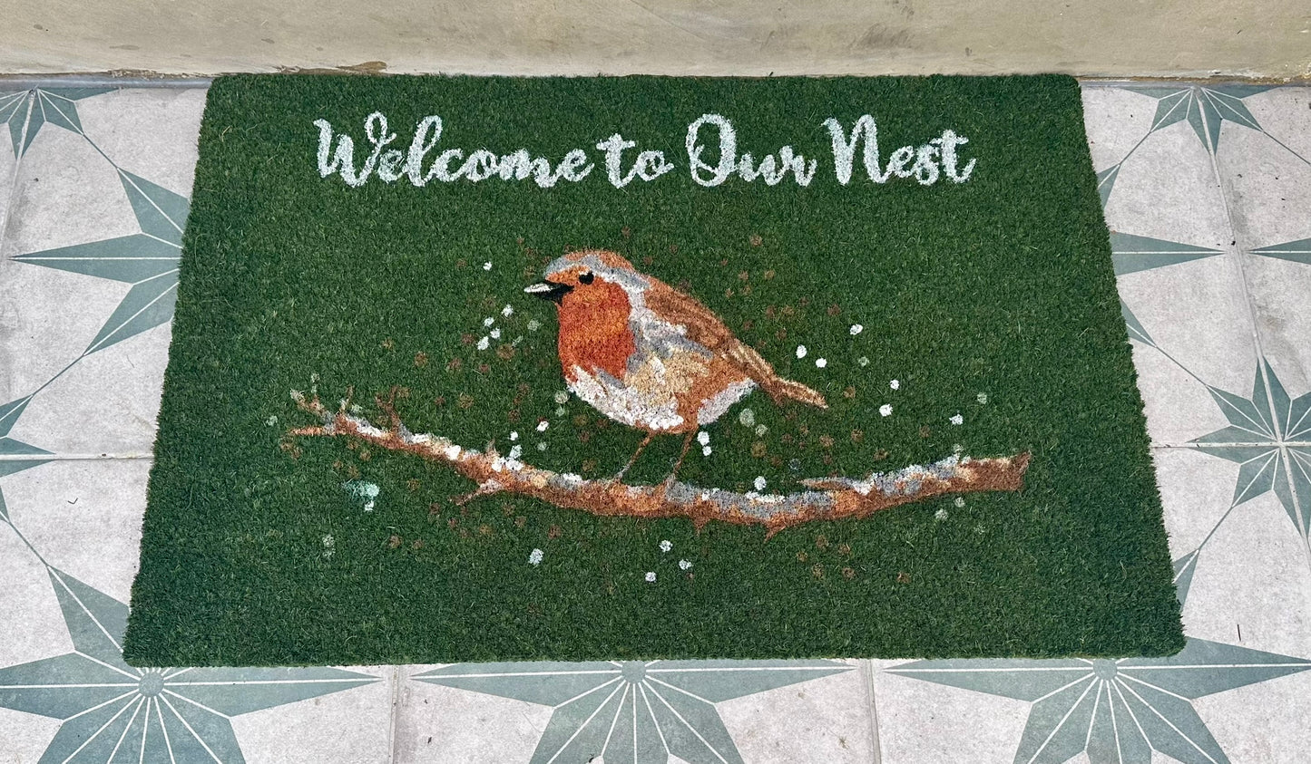 Festive Christmas robin coir doormat with “Welcome to Our Nest” message, green natural fibre mat perfect for holiday home décor and seasonal gifts.
