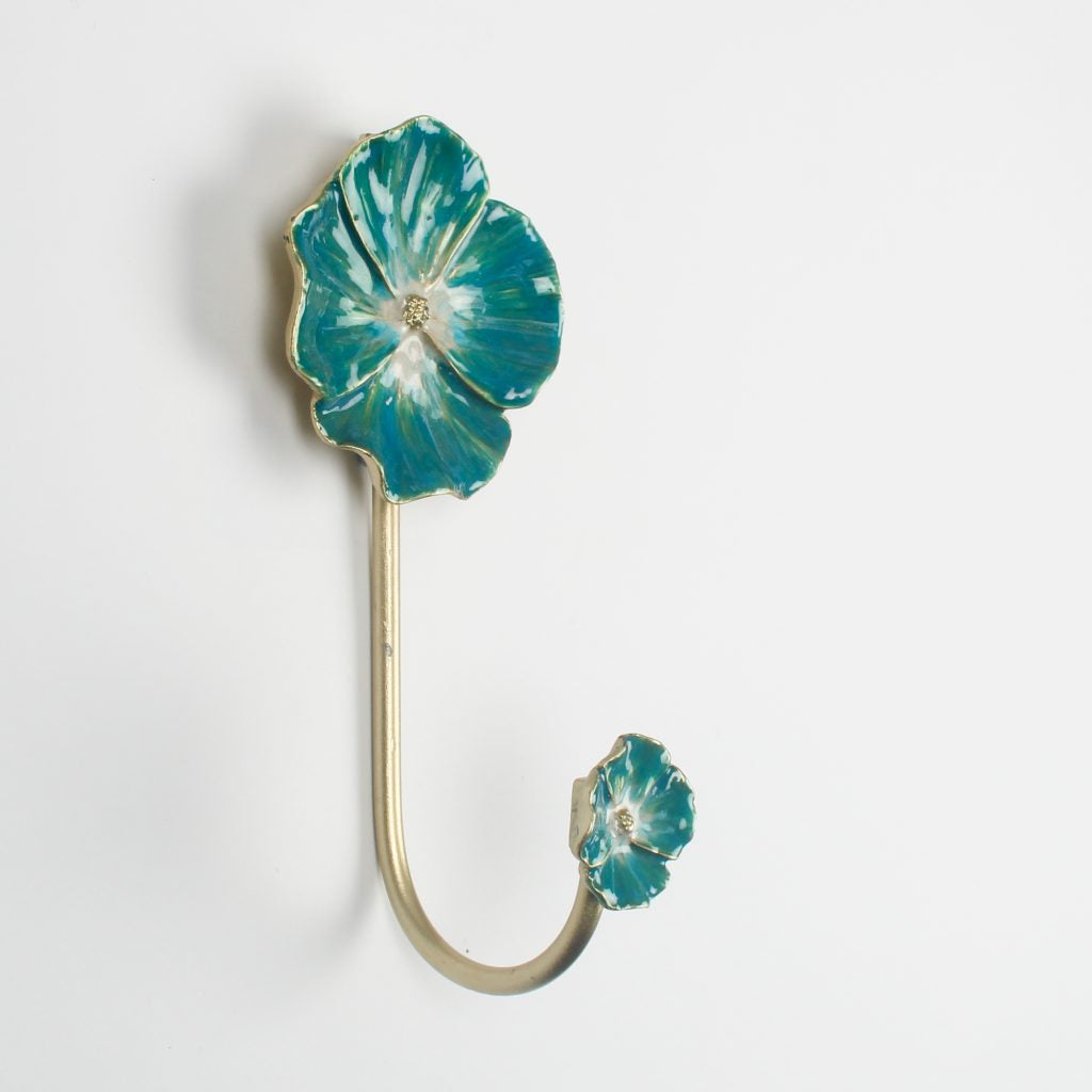 Decorative brass effect flower hook with enamel turquoise cornflower blue design on a white background