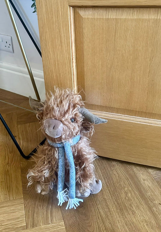 adorable fluffy Highland cow doorstop, a cute and functional home accessory for rustic or country-style decor