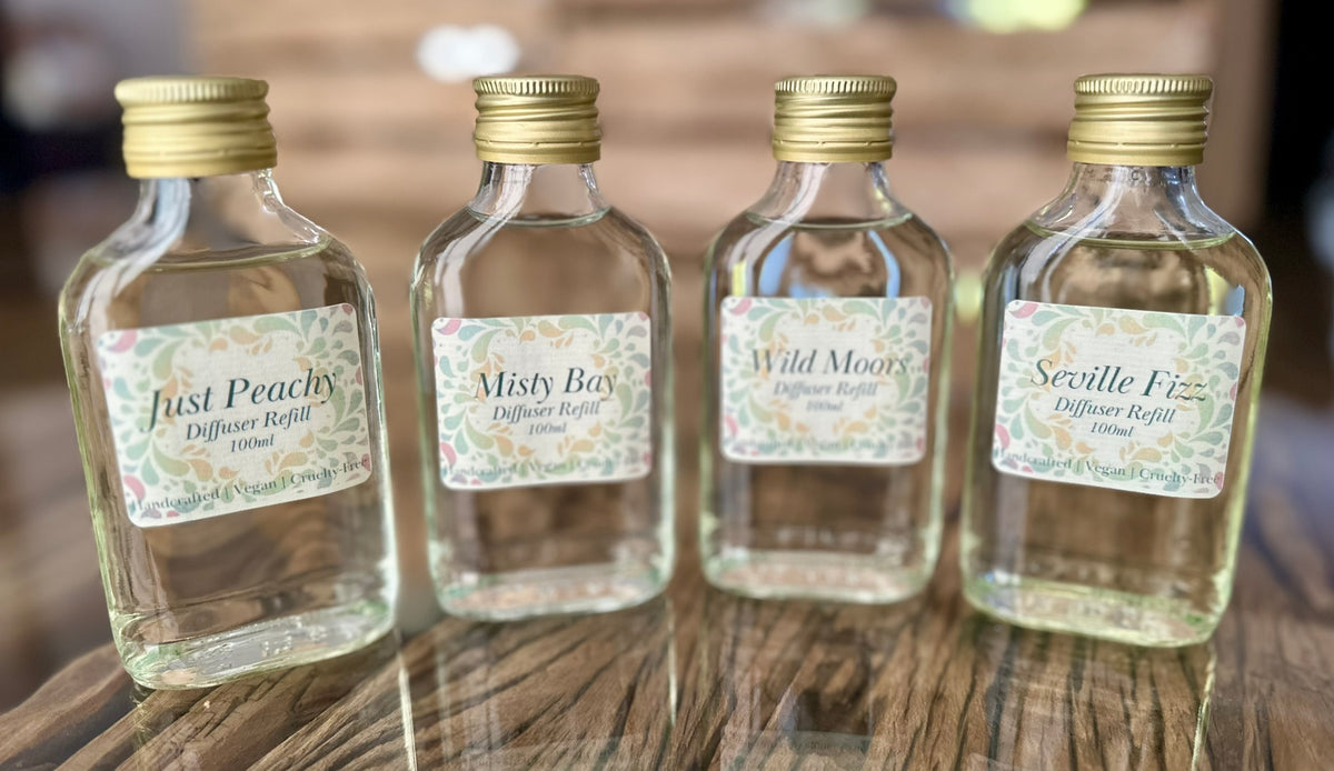 4 glass refill bottles with gold lids of our diffusers with glycerin oil and essential oils or perfume grade oils