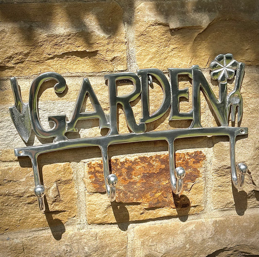 Rustic metal garden sign with hooks for hanging tools, jackets or accessories