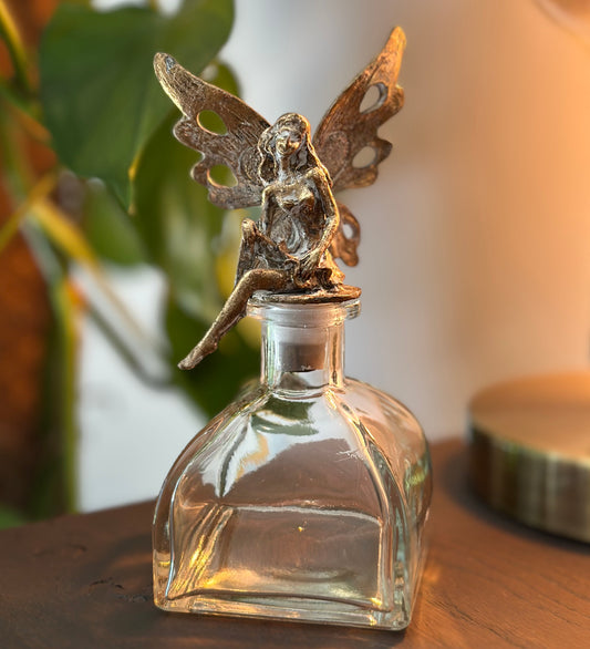 Glass jar with golden fairy stopper, decorative and whimsical storage for home or gifting