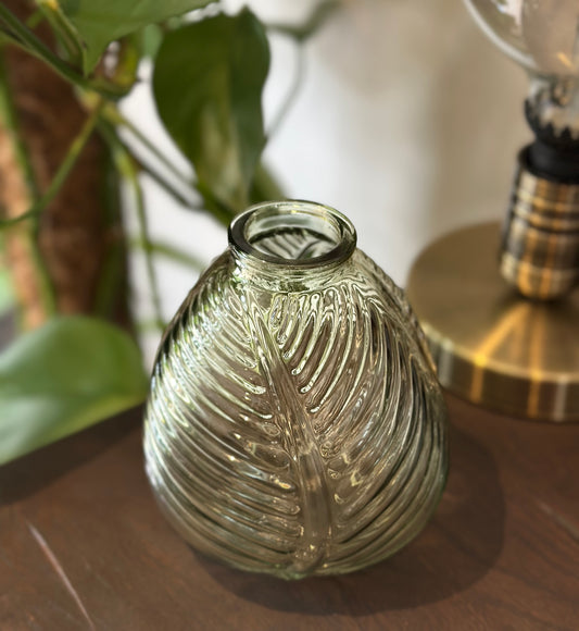 Clear glass vase with textured surface on a wooden surface