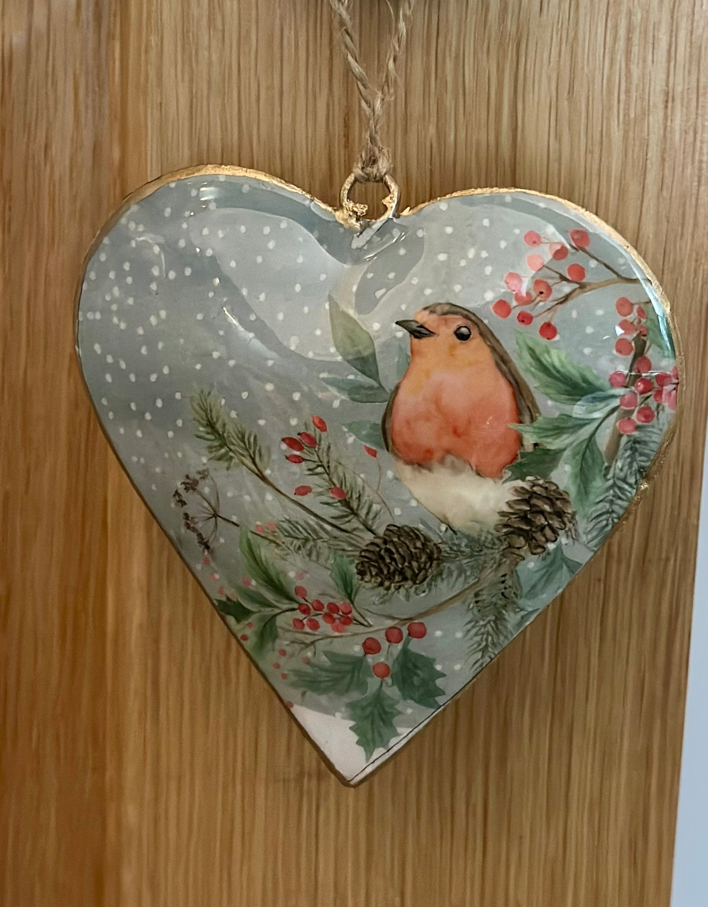 Rustic country-style heart robin Christmas decoration with holly and pinecone design — hanging metal heart ornament for festive home interiors.