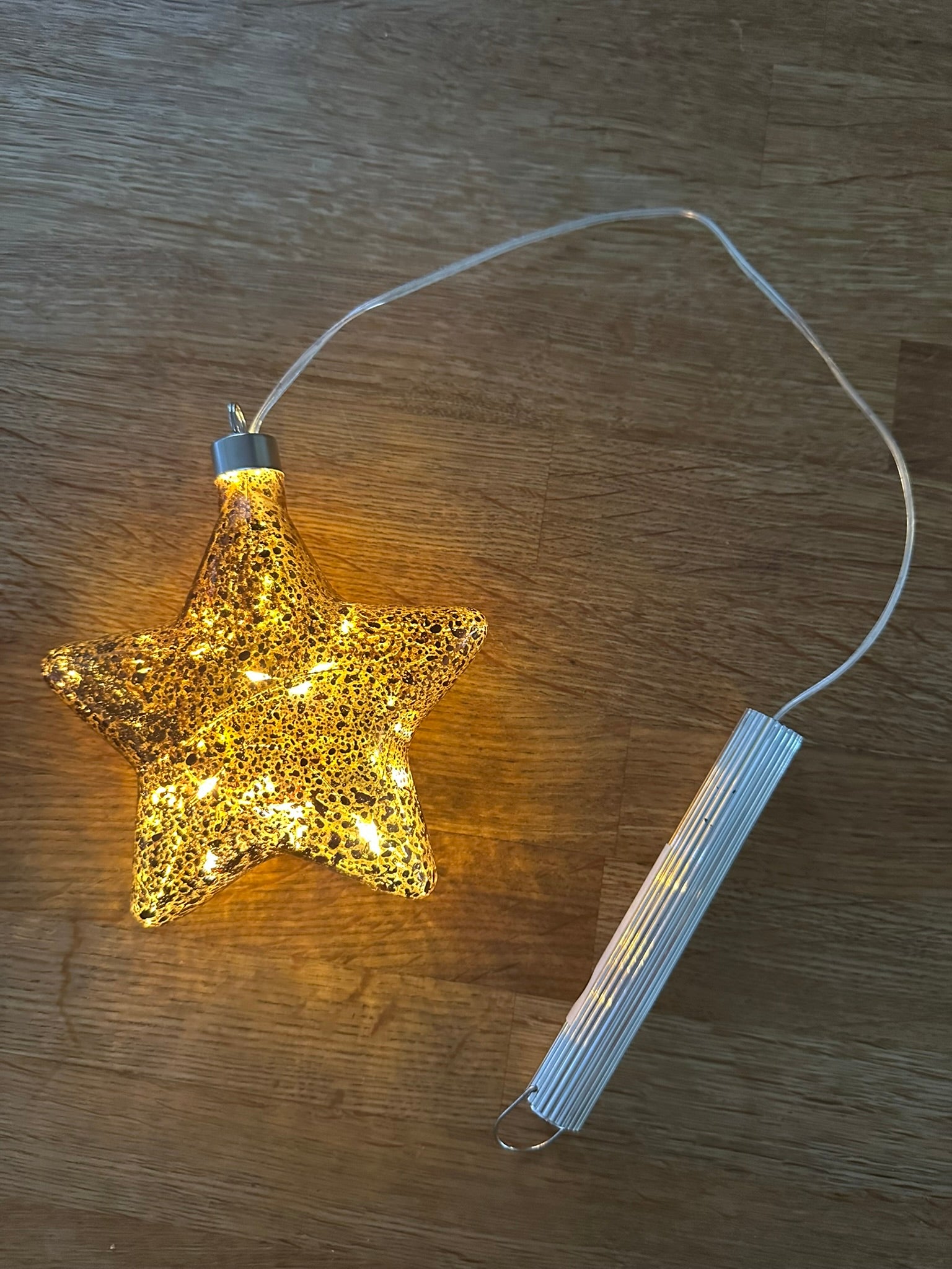 Elegant bronze glass star light hanging decoration, ideal for modern Christmas home décor, stylish metallic festive ornament, and thoughtful holiday gift idea.