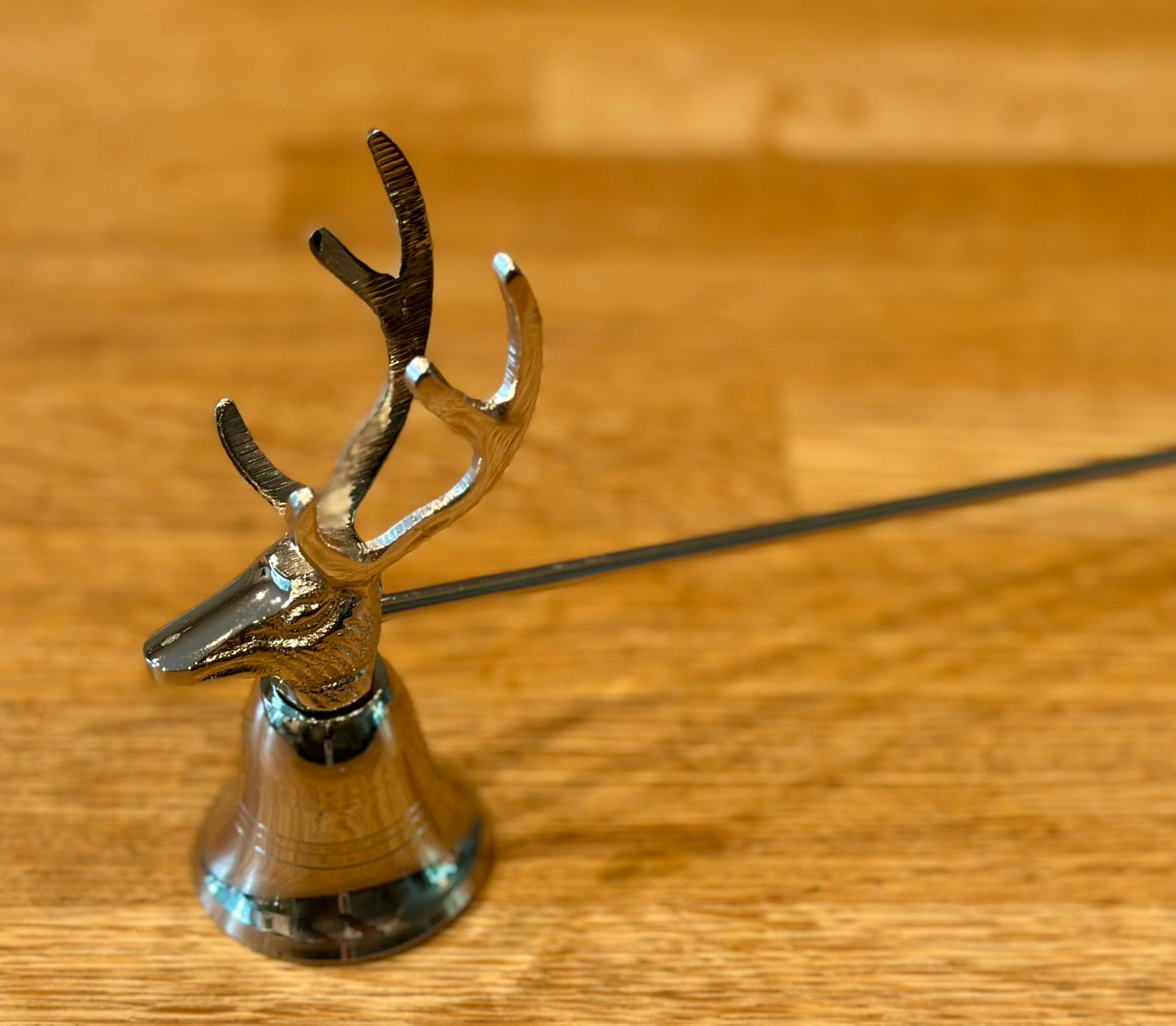 Silver aluminium stag candle snuffer, decorative and functional candle accessory with deer motif, perfect festive home décor and Christmas tableware gift.