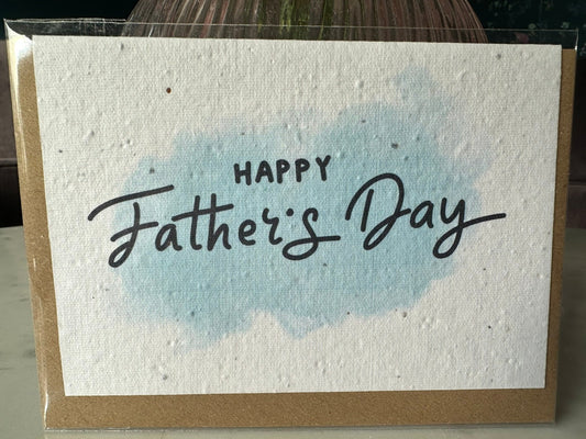 blue watercolour splash with the words 'happy fathers day' in black text on top