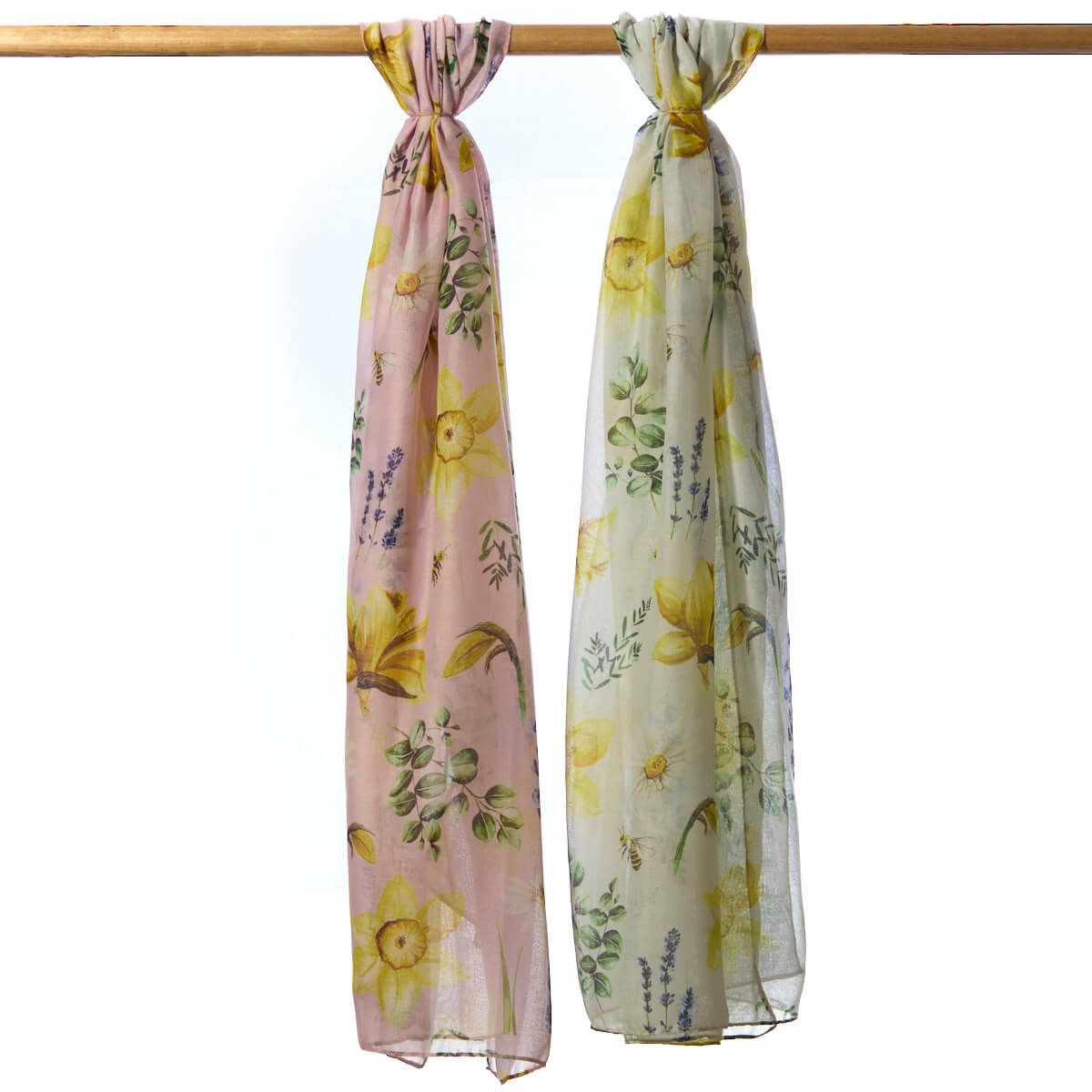 Two floral scarves on a wooden rod with a white background
