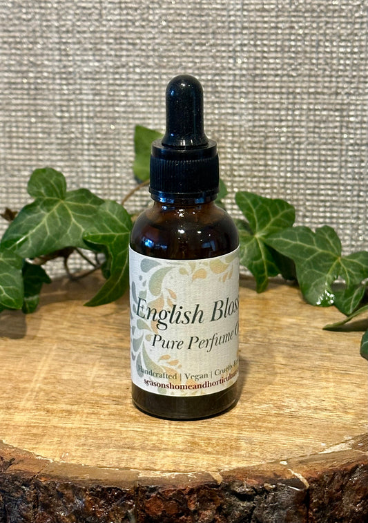 English Blossom perfumed oil in a glass bottle with peony, jasmine, and amber fragrance, featuring a soft floral scent and elegant natural aromatherapy style