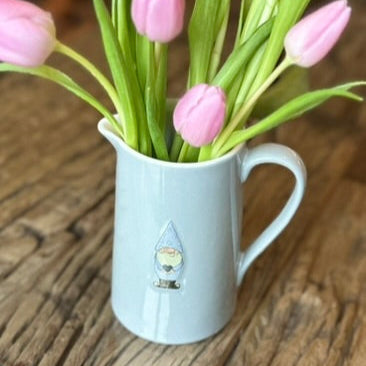 a gonk jug with flowers in - as if a vase