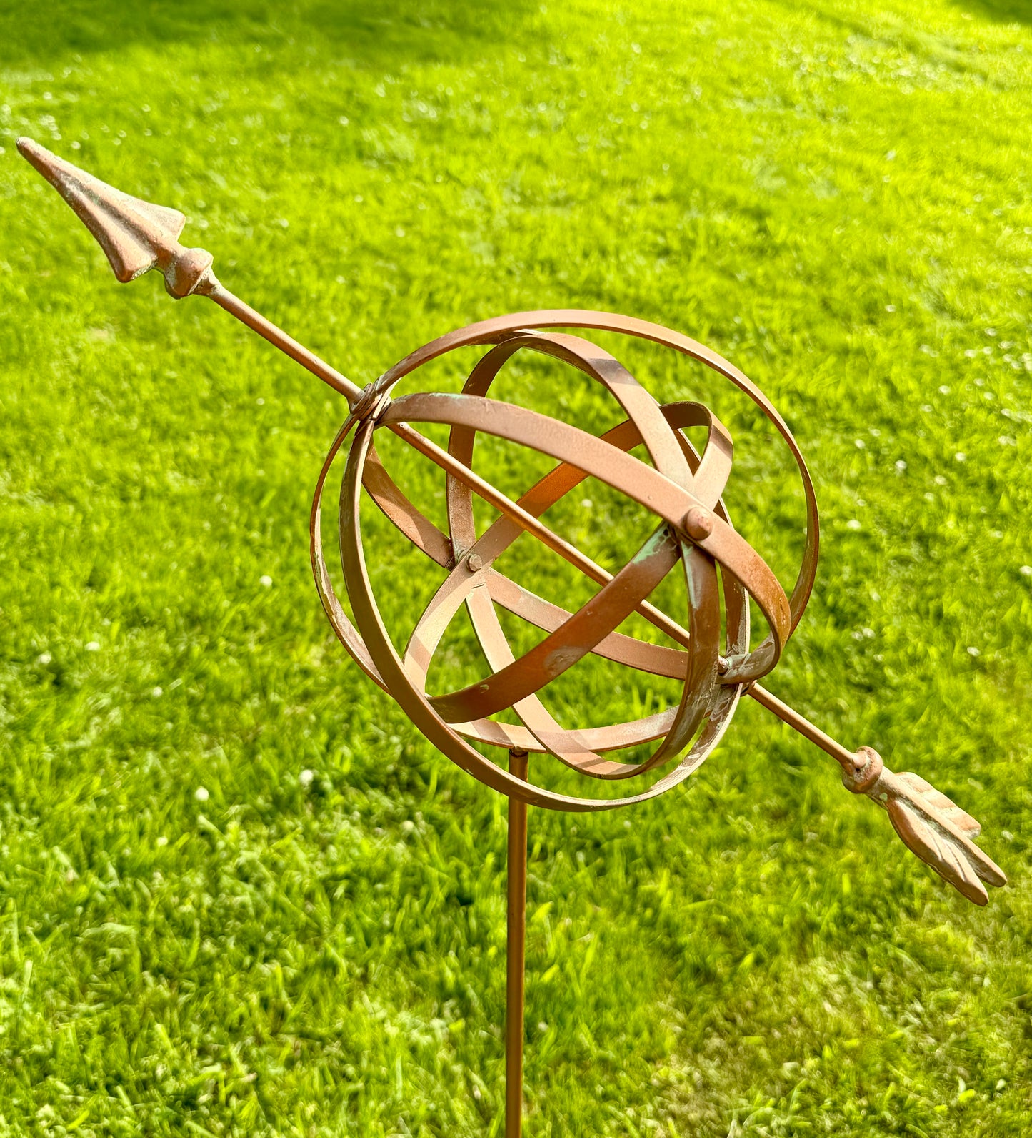 Bronze armillary sphere garden stake displayed outdoors as elegant garden ornament for borders and lawns