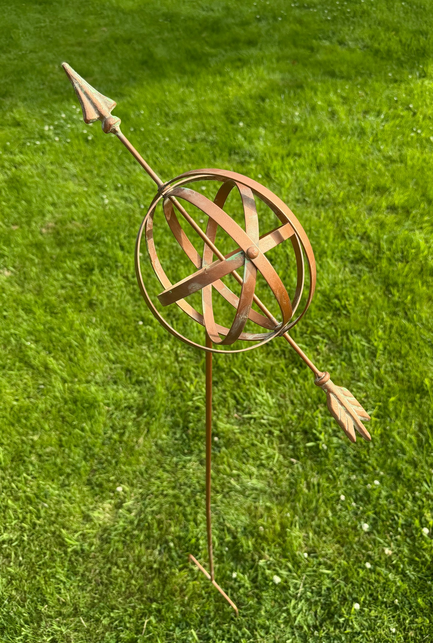 Decorative armillary garden sculpture with bronze finish adding classic style to outdoor spaces