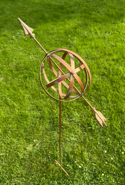 Decorative armillary garden sculpture with bronze finish adding classic style to outdoor spaces