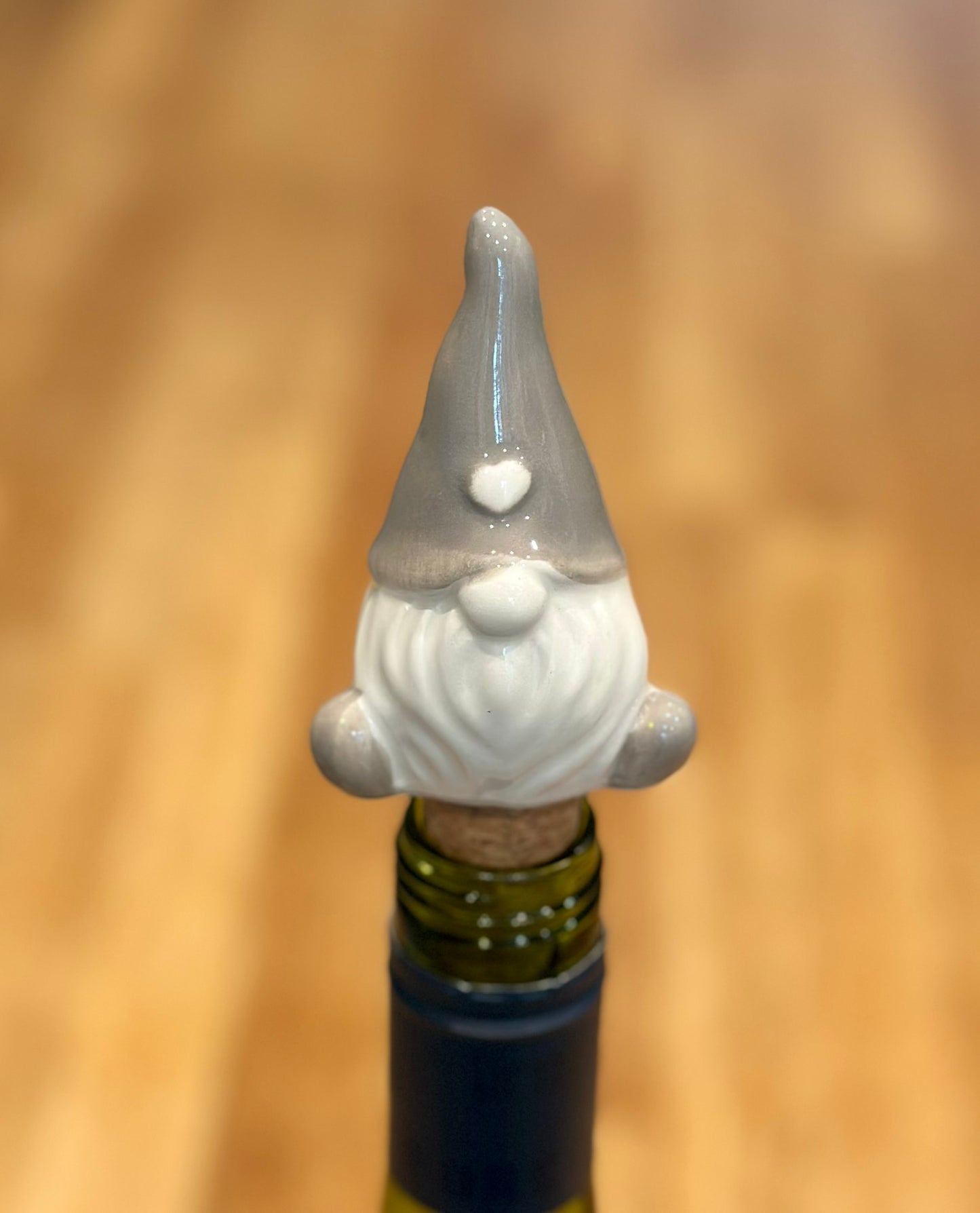 Festive ceramic and cork gonk bottle stopper with Christmas motif, unique wine accessory and decorative barware piece for holiday entertaining and gifting.