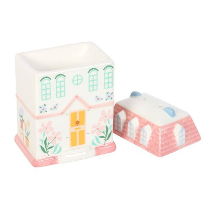 Charming ceramic house shaped wax melt burner with floral detailing ideal for gifts and cosy home interiors