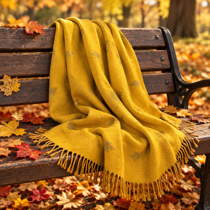 A mustard yellow scarf with small grey bee motifs and fringed edges, draped on a cream-colored mannequin torso with a wooden neck cap against a plain white background.