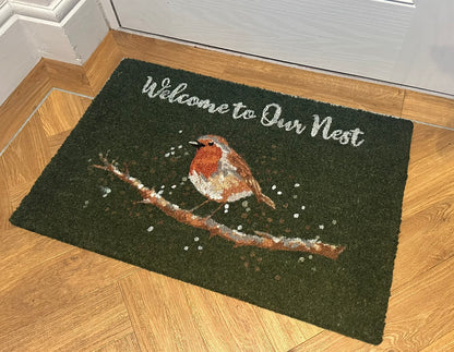 Coir robin green doormat with “Welcome to Our Nest” text, natural fibre entrance mat featuring bird design for decorative home and garden use.
