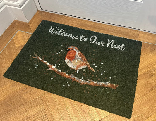 Coir robin green doormat with “Welcome to Our Nest” text, natural fibre entrance mat featuring bird design for decorative home and garden use.