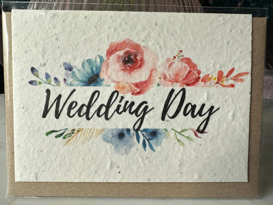 a wildflower seed card with 'wedding day' written in script, bordered by flowers in a watercolour style. 