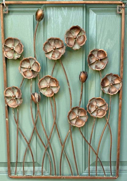 Weatherproof cornflower wall art creating an eye catching floral feature in outdoor living areas