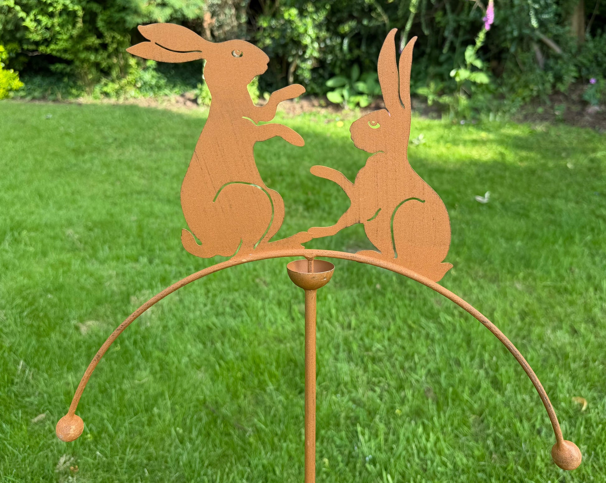 Weatherproof rabbit garden balancer on stake adding movement and character to outdoor garden spaces