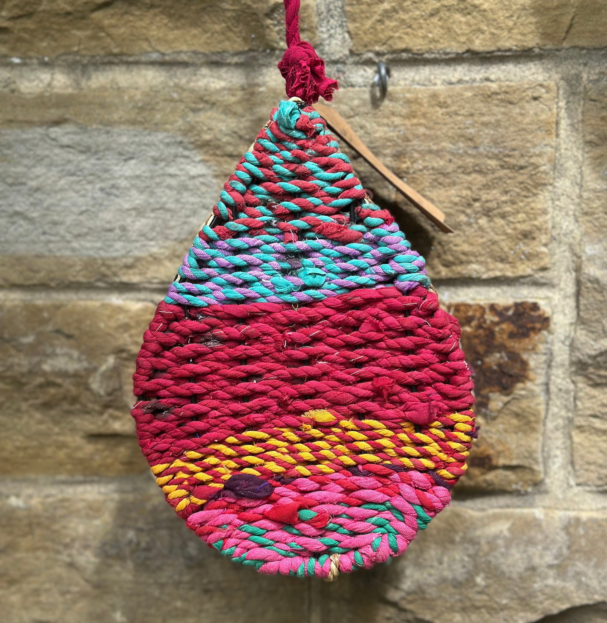 Decorative insect house crafted with recycled sari and natural materials, perfect for attracting bees and bugs
