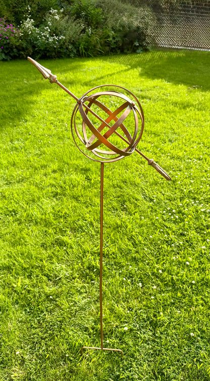 Weatherproof armillary sphere garden stake creating an eye catching focal point in garden borders