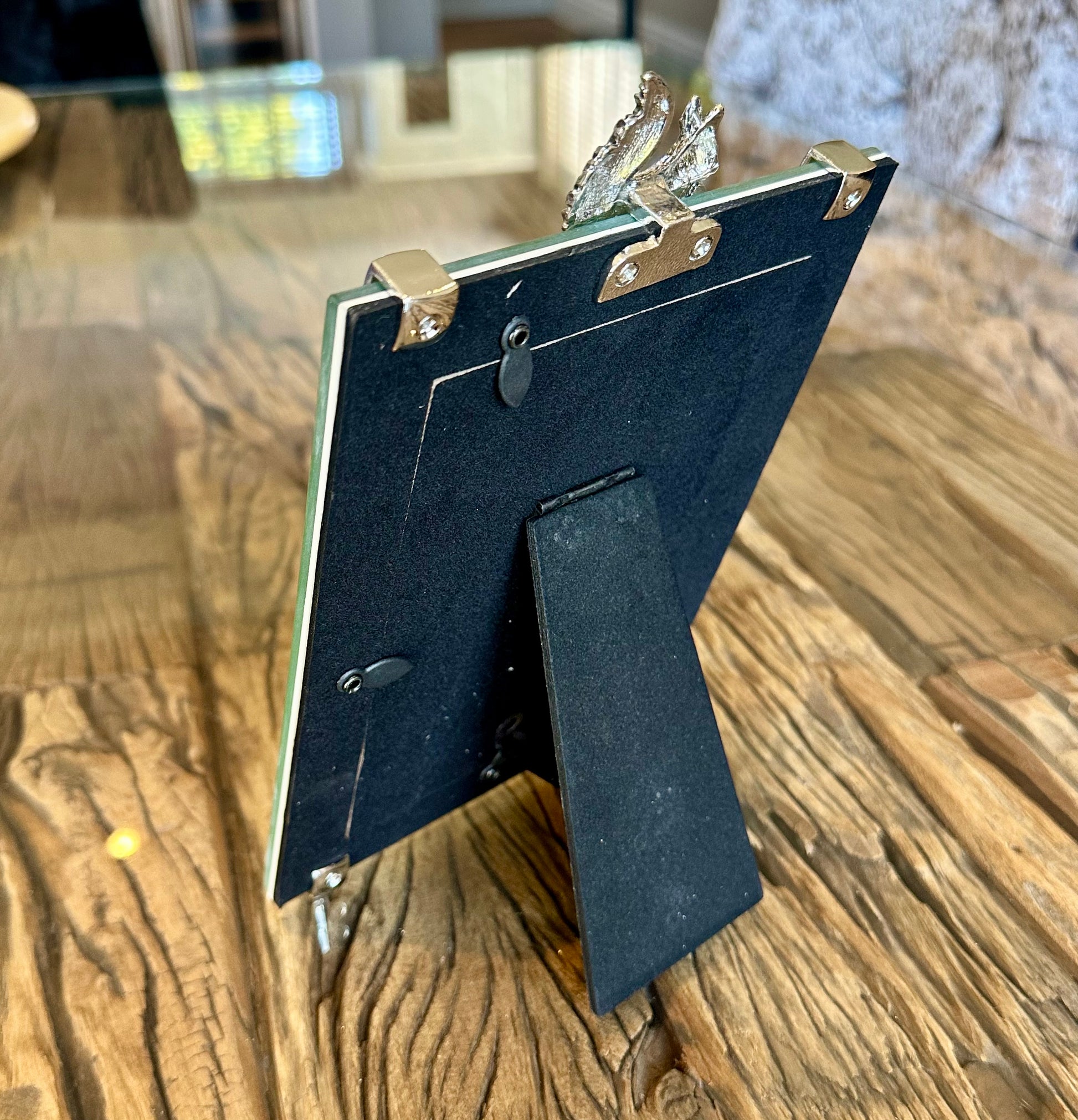 the back of the phot frame, featuring a velvet like material. 