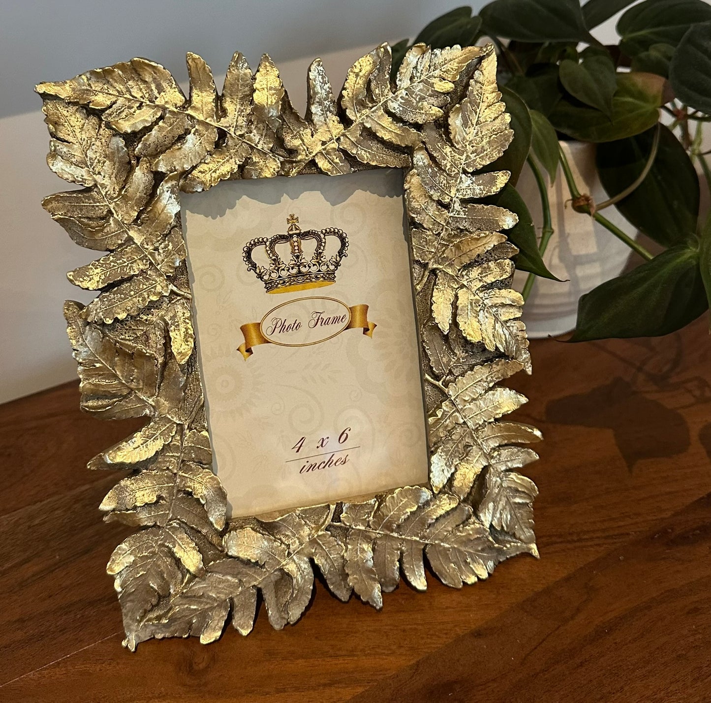 Gold leaf photo frame for 4x6 pictures — elegant metallic home decor piece, perfect for stylish interiors or as a thoughtful decorative gift.
