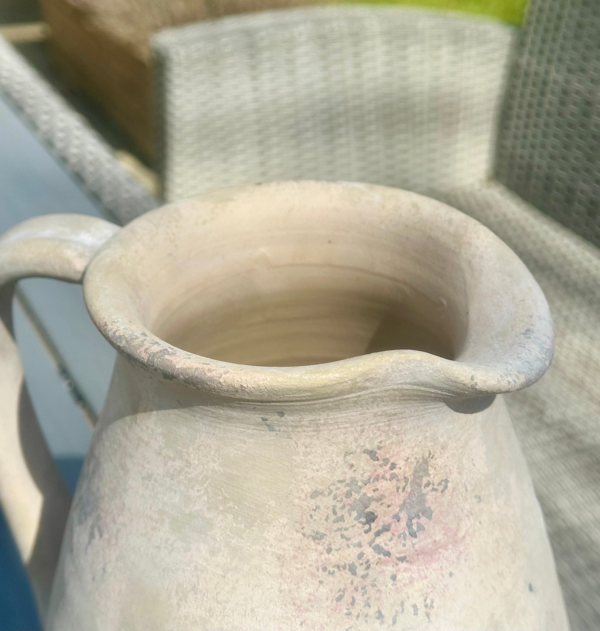 a close up image of the spout of the vase