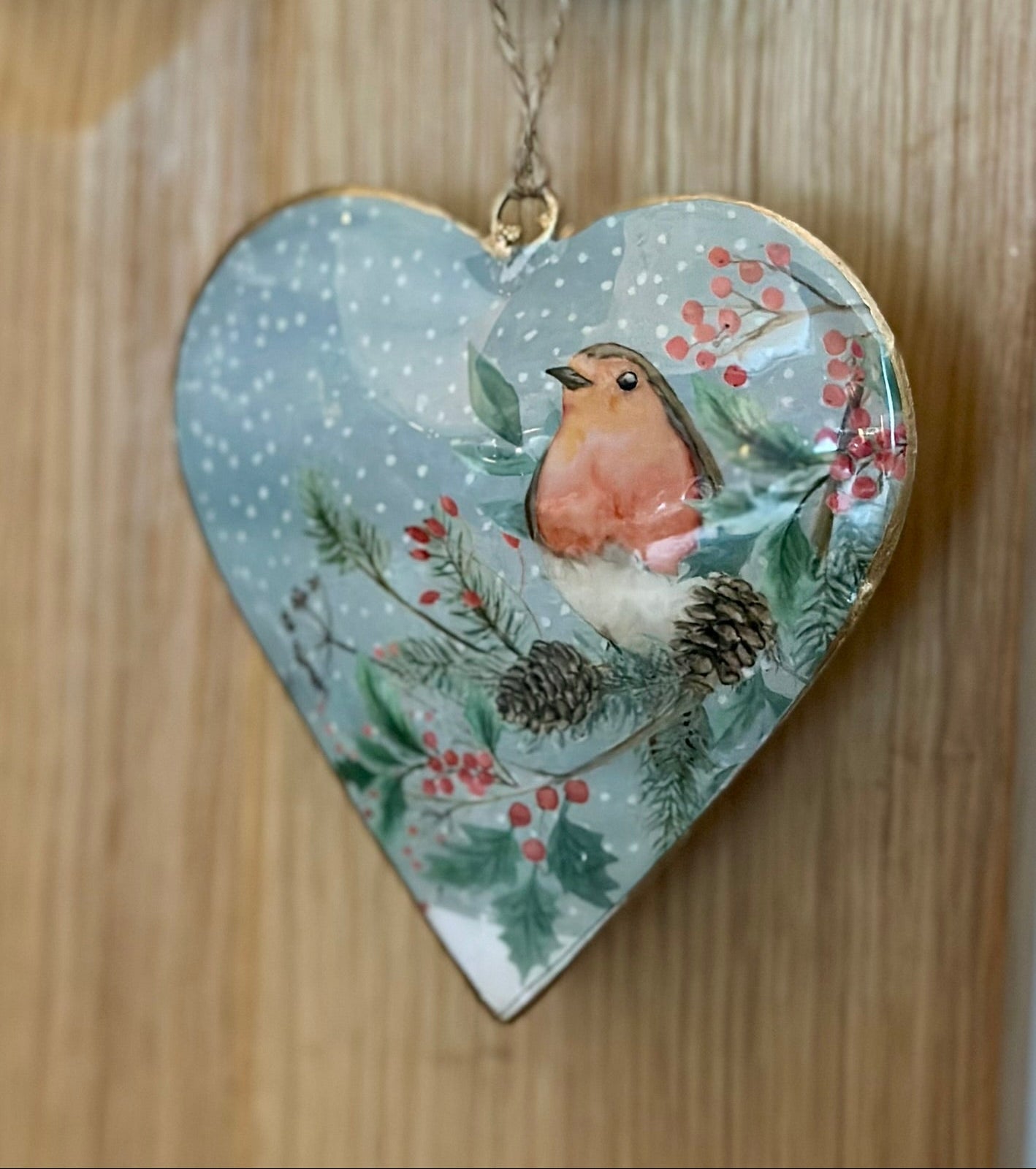 Heart-shaped hanging robin Christmas decoration with holly, berries, and pine design — festive metal ornament for winter home décor and holiday gifts.