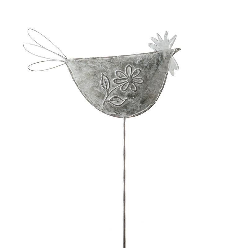 Decorative metal chicken figure with floral design on a white background