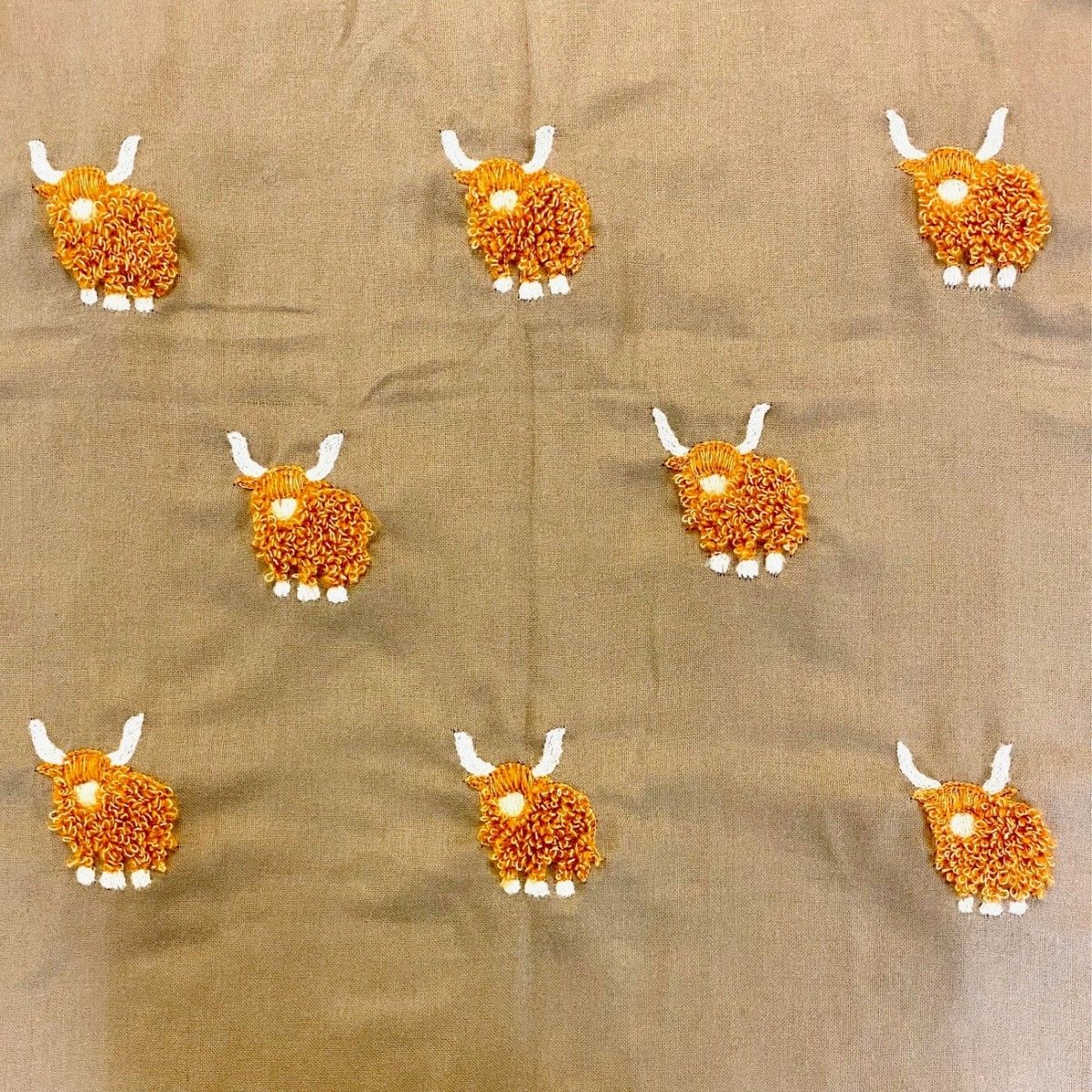a close up of the highland cow stitching