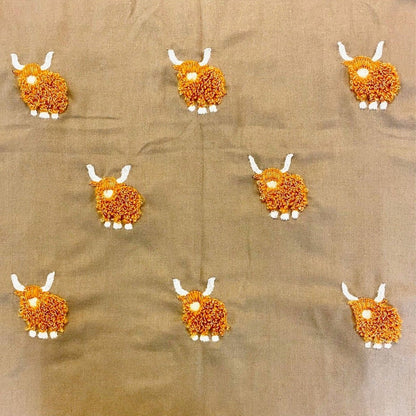 a close up of the highland cow stitching