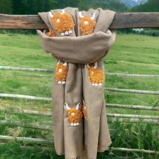 a scarf with highland cows stitched onto it