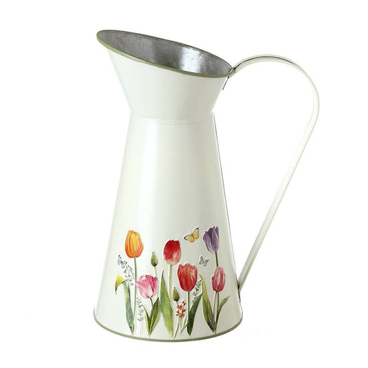 White metal pitcher with tulip floral design on a white background