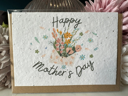 an image of an envelope of flowers bordered with the script of 'happy mother's day' on wildflower seed paper. 
