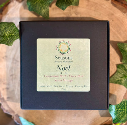 Luxury Noël wax melts, eco-friendly and cruelty-free, warm orange and cedarwood scent, long-lasting festive fragrance.