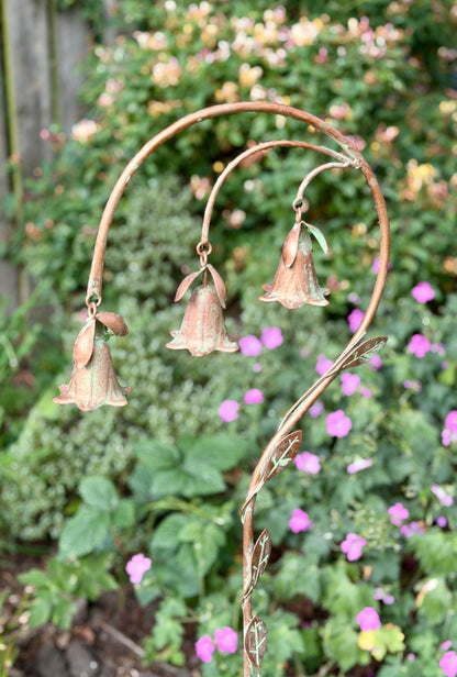 Decorative metal flower stake with hanging bells for cottage garden styling and landscaping
