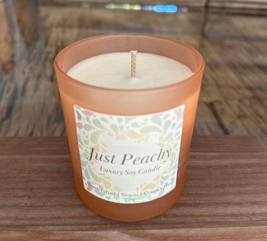 just peachy scented candle in frosted glass peach coloured glass. 