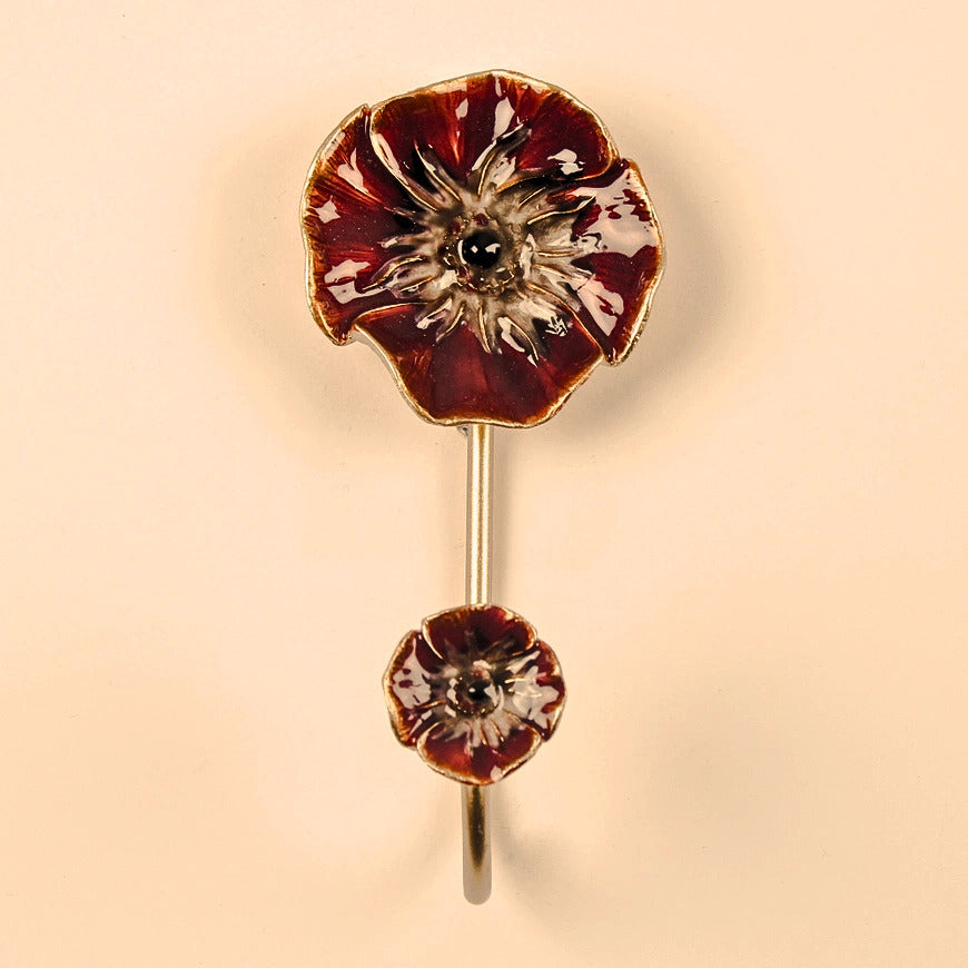 Floral hook with red and gold design on a beige background