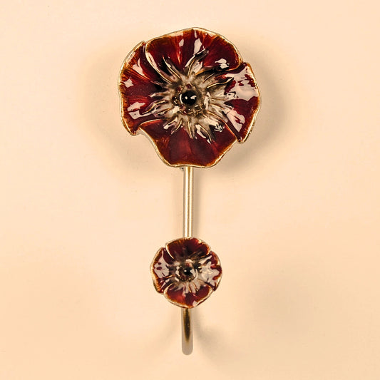 Floral hook with red and gold design on a beige background