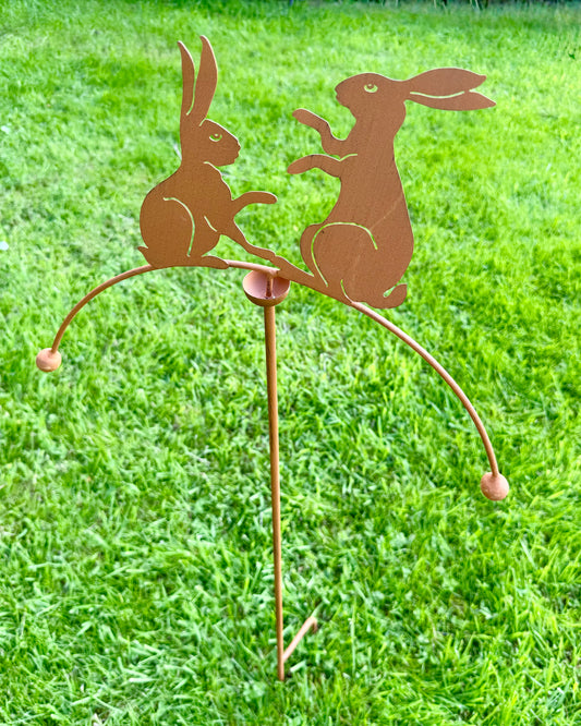 Rustic metal hare garden stake balancer displayed outdoors as decorative garden ornament for lawns and borders